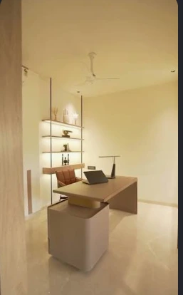 Warm-toned office with a desk, upholstered chair and illuminated open shelving