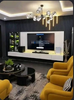 Living room with dark fluted wall, white media console and mustard seating